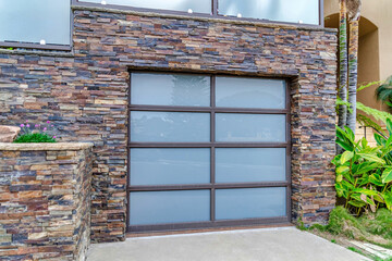 Glass paned garage door and stone brick wall of house in San Doego California