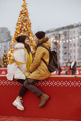 Obraz premium Happy cheerful and young caucasian couple are having fun while dating together outdoors in a city
