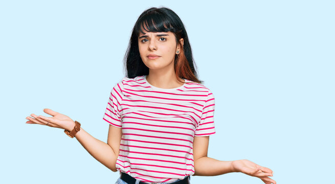 Young hispanic girl wearing casual clothes clueless and confused with open arms, no idea concept.