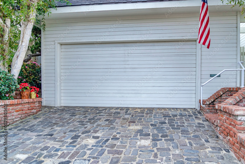 Wall mural garage of house in san diego california with white door and wall cladding