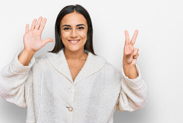 Young brunette woman wearing casual clothes showing and pointing up with fingers number eight while smiling confident and happy.