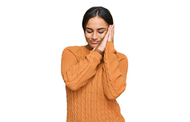 Young brunette woman wearing casual winter sweater sleeping tired dreaming and posing with hands together while smiling with closed eyes.