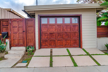 Home in San Diego California with glass paned garage door beside wooden gate