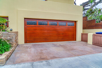 Brown garage door with frosted glass panes at San Diego California home facade