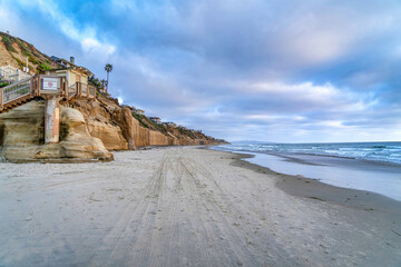 Ocean front houses with view of sandy beach and blue sea water in San Diego CA