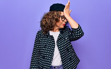 Middle age beautiful woman wearing casual jacket and french beret over purple background surprised...