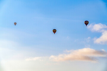 Hot air balloons and cloudy blue sky in San Diego California with bright sun