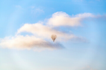 Hot air balloon floating in the air against clouds and blue sky in San Diego CA