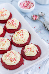 Red velvet cupcakes with white icing and heart shaped decorations