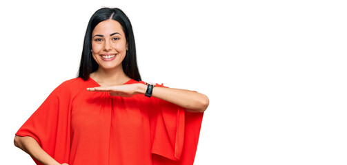 Beautiful young woman wearing casual clothes gesturing with hands showing big and large size sign, measure symbol. smiling looking at the camera. measuring concept.