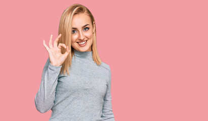 Beautiful caucasian woman wearing casual clothes smiling positive doing ok sign with hand and fingers. successful expression.