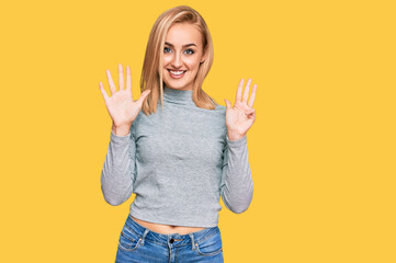 Beautiful caucasian woman wearing casual clothes showing and pointing up with fingers number nine...