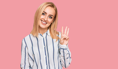 Beautiful caucasian woman wearing casual clothes showing and pointing up with fingers number three while smiling confident and happy.