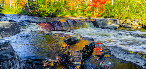 Autumn Waterfall Panorama. Gorgeous Upper Peninsula Michigan waterfall landscape at the Canyon Falls Scenic area between Baraga and Marquette, Michigan.