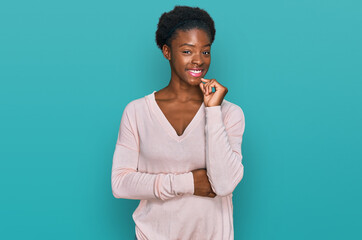 Young african american girl wearing casual clothes looking confident at the camera smiling with...