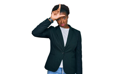 Young african american girl wearing business clothes making fun of people with fingers on forehead...