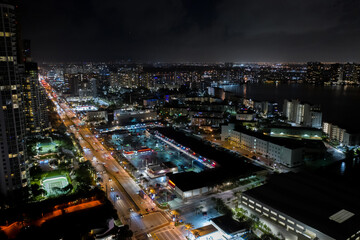 Shopping plaza strip mall night aerial photo