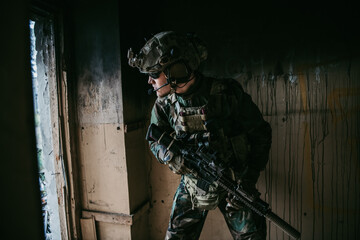 Soldier in combat. Urban combat training, soldier entering abandoned building. Anti terrorist...