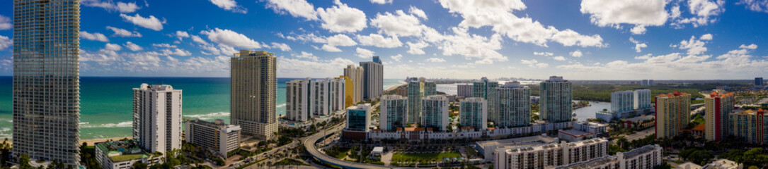 Aerial panorama Sunny Isles Beach facing south at 163rd Street highrise beachfront condominiums in photo