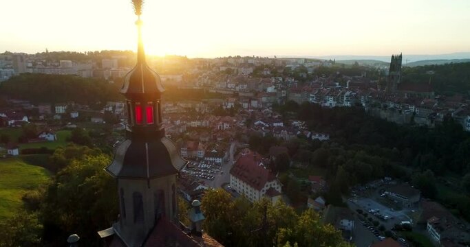 Drone aerial view of fribourg switzerland village sunset church tower and city