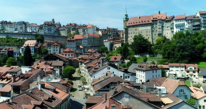Drone aerial rising over fribourg switzerland village - city summer