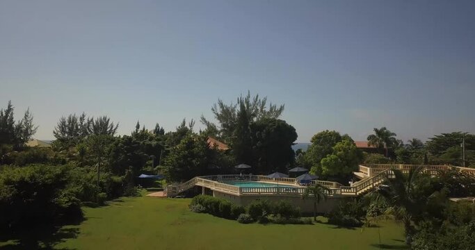 A sunny afternoon aerial shot of garden and pool