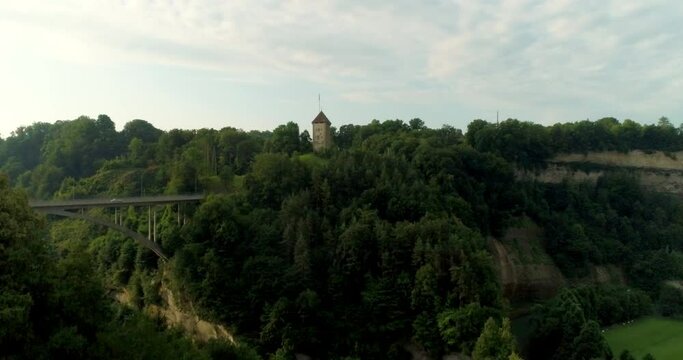 Drone aerial rising over bridge in fribourg switzerland forest