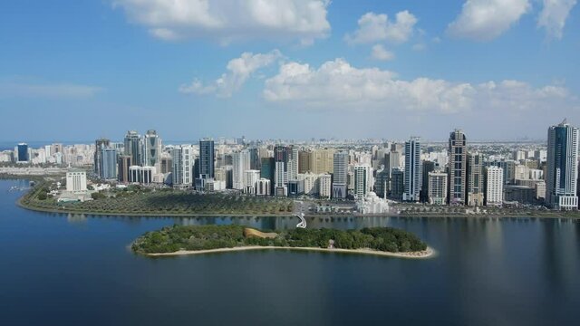 4K: Sharjah From the Top, Aerial view of Sharjah city and Khalid lake, Al Noor Mosque and Island, Travel tourism business in the United Arab Emirates.