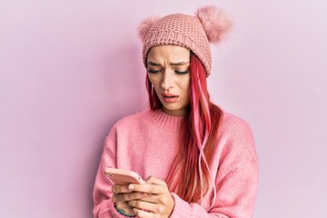 Young caucasian woman having conversation talking on the smartphone clueless and confused...