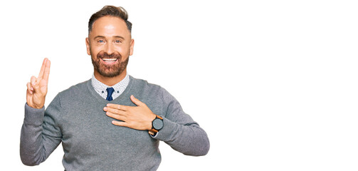Handsome middle age man wearing business clothes smiling swearing with hand on chest and fingers...