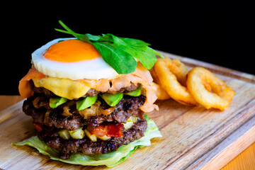 Close-up of home made tasty burgers on wooden table.
