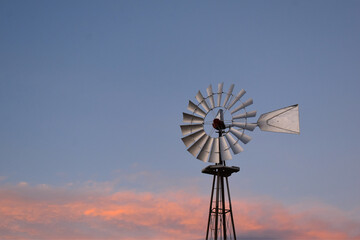 windmill on a hill at sunset