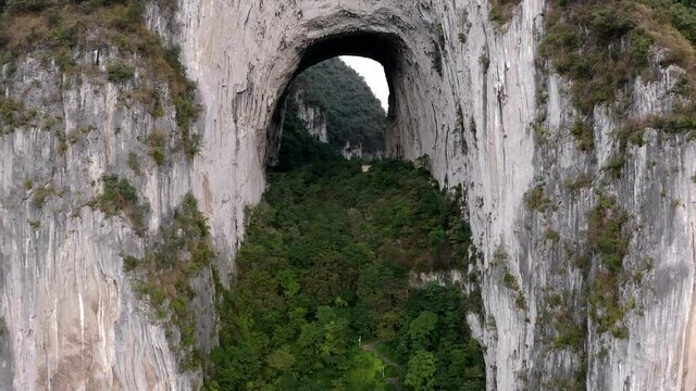 Amazing natural archway in China karst mountain, Great Arch of Getu, aerial view