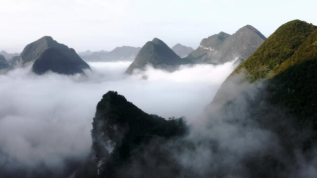 Beautiful cloudy karst mountains in Asia, dramatic aerial view