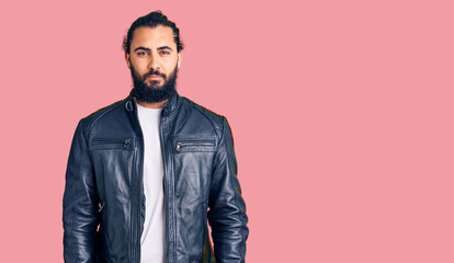 Fototapeta premium Young arab man wearing casual leather jacket looking sleepy and tired, exhausted for fatigue and hangover, lazy eyes in the morning.