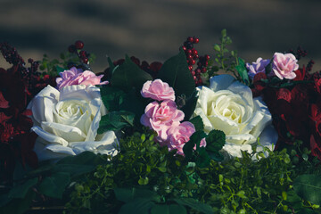 Bouquet of roses and hydrangea with greenery and cranberry blur background