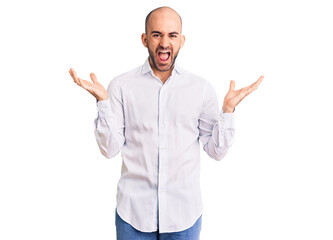 Fototapeta premium Young handsome man wearing elegant shirt celebrating victory with happy smile and winner expression with raised hands