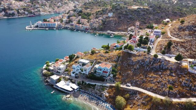 View on Symi (Simi) island harbor port, classical ship yachts, houses on island hills, Aegean Sea bay. Greece islands holidays vacation travel tours from Rhodos island. Symi, Greece,  Dodecanese.