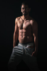 Fototapeta na wymiar portrait on dark background of muscular young model man