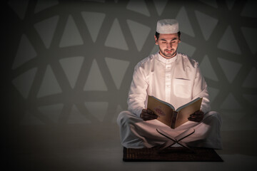 asian muslim prayer sitting in mosque and read holy al quran book