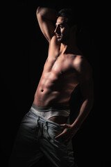 portrait on dark background of muscular young model man