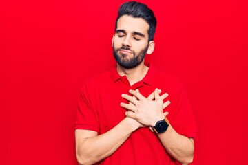 Young handsome man with beard wearing casual polo smiling with hands on chest, eyes closed with grateful gesture on face. health concept.