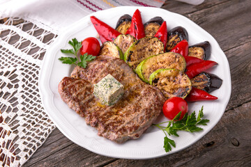 Pork steak grilled with grilled vegetables. Balkan cuisine. National cuisine. Nourishing, useful, natural. Rustic cuisine.