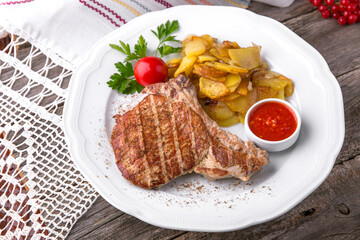 Pork steak grilled with grilled vegetables. Balkan cuisine. National cuisine. Nourishing, useful, natural. Rustic cuisine.