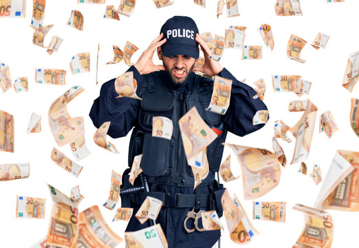 Young handsome man with beard wearing police uniform with hand on head for pain in head because stress. suffering migraine.