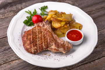 Pork steak grilled with grilled vegetables. Balkan cuisine. National cuisine. Nourishing, useful, natural. Rustic cuisine.