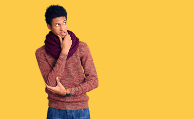 Young african american man wearing casual winter sweater and scarf thinking worried about a question, concerned and nervous with hand on chin
