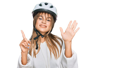 Teenager caucasian girl wearing bike helmet showing and pointing up with fingers number six while smiling confident and happy.