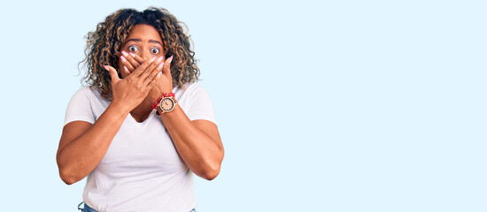 Young african american plus size woman wearing casual clothes shocked covering mouth with hands for...