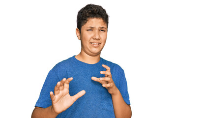 Teenager hispanic boy wearing casual clothes disgusted expression, displeased and fearful doing disgust face because aversion reaction. with hands raised © Krakenimages.com